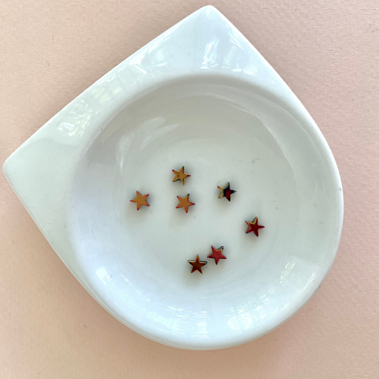 Acerina: Estrella rosa con dorado 4mm